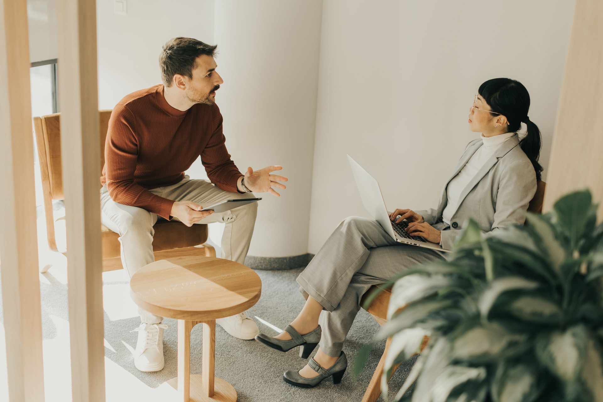 Engaging conversation between colleagues in a modern workspace
