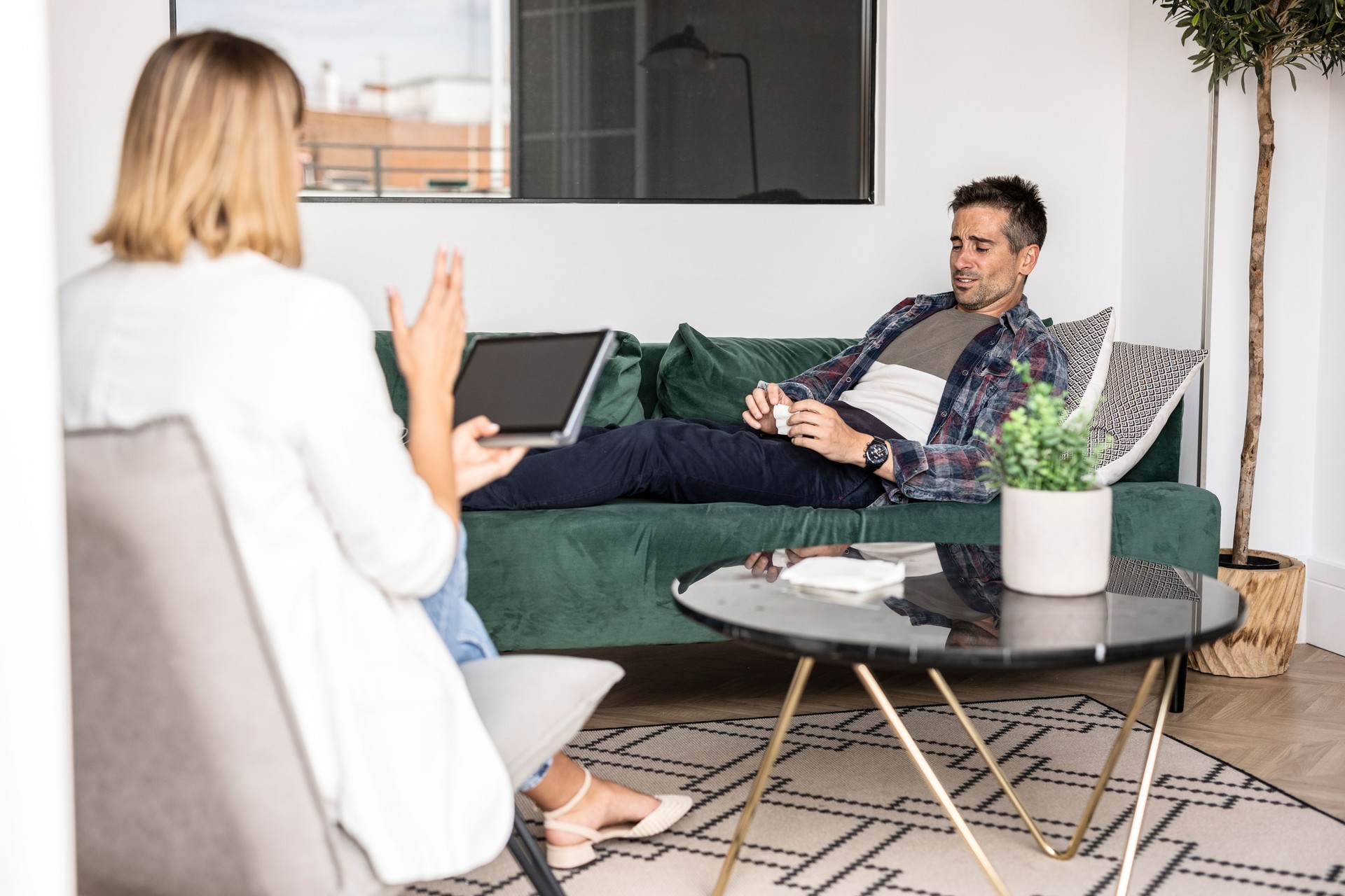 Therapist Using Tablet to Discuss Issues with Male Client